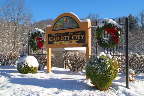 Welcome to historic Ellicott City, Maryland sign in snow.