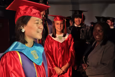 Graduating students in academic regalia (aka cap and gown).