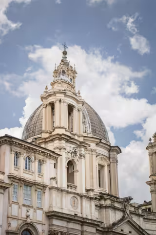 Stone building with clouds on a blue sky